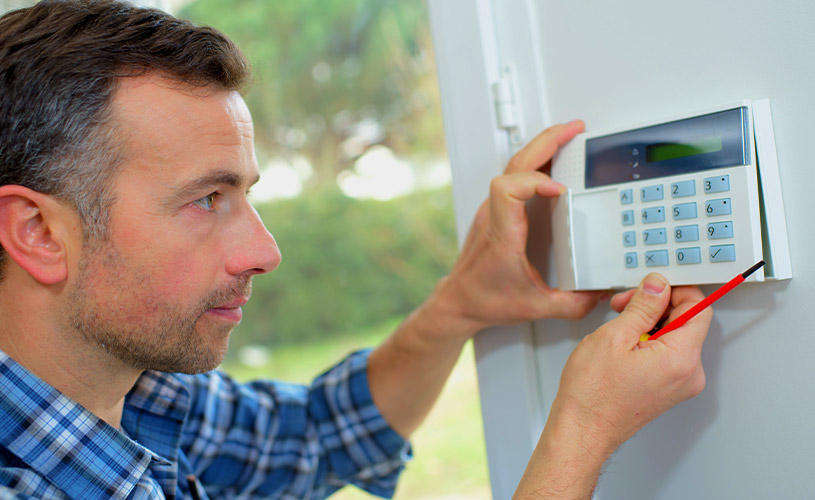 electrician installing house alarm system