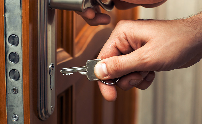 man unlocking door