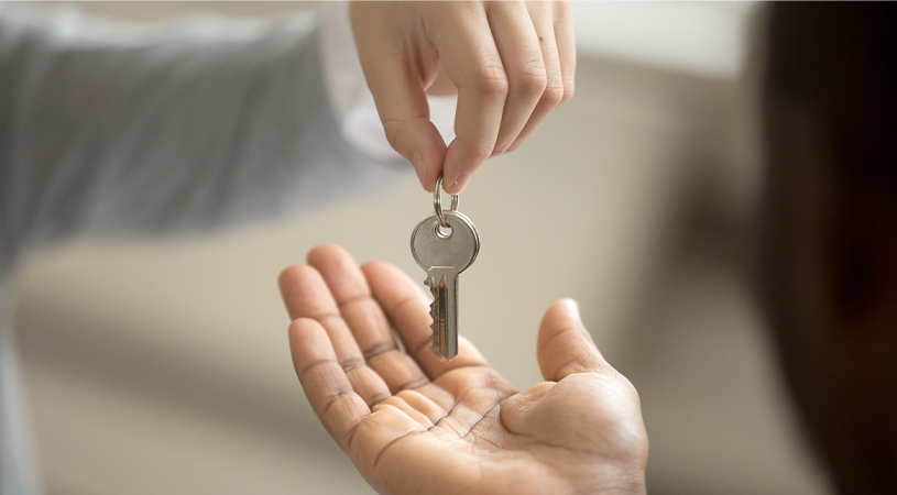 woman passing house keys to tenant